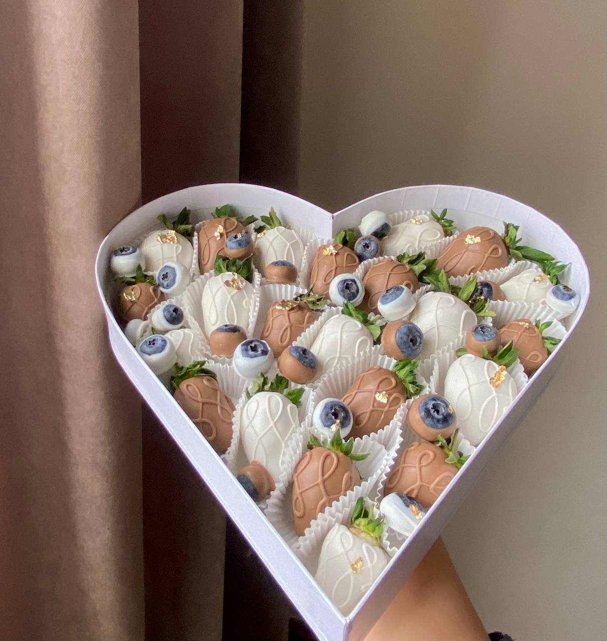 Heart-shaped box with strawberries and blueberries